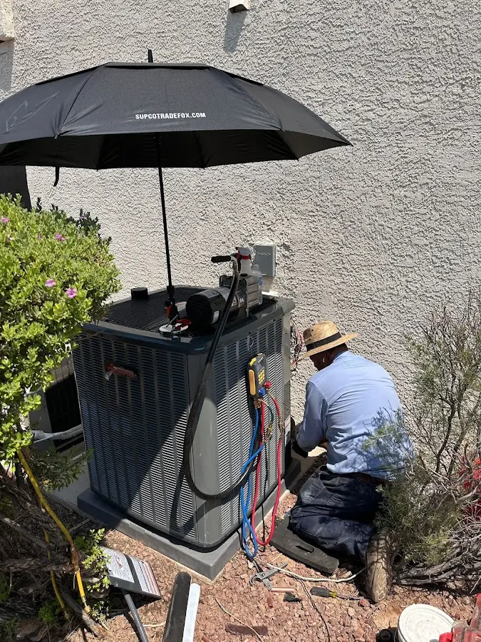 HVAC technician performing outdoor AC maintenance in McComb
